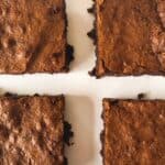 gluten free fudge brownies cut into squares on a white surface