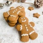 Gluten free gingerbread men stacked together with acorns in the background