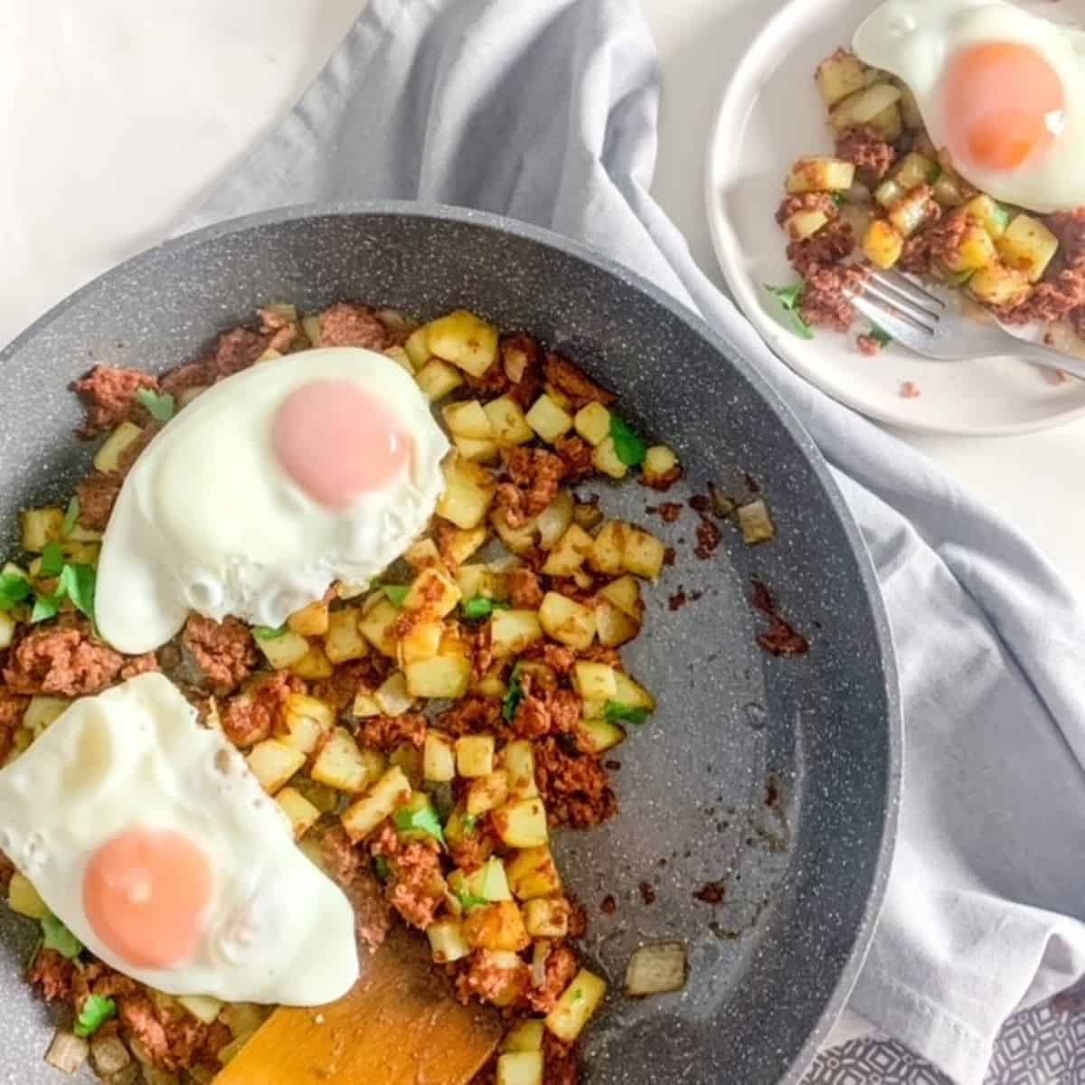 corned beef hash with eggs on a large skillet