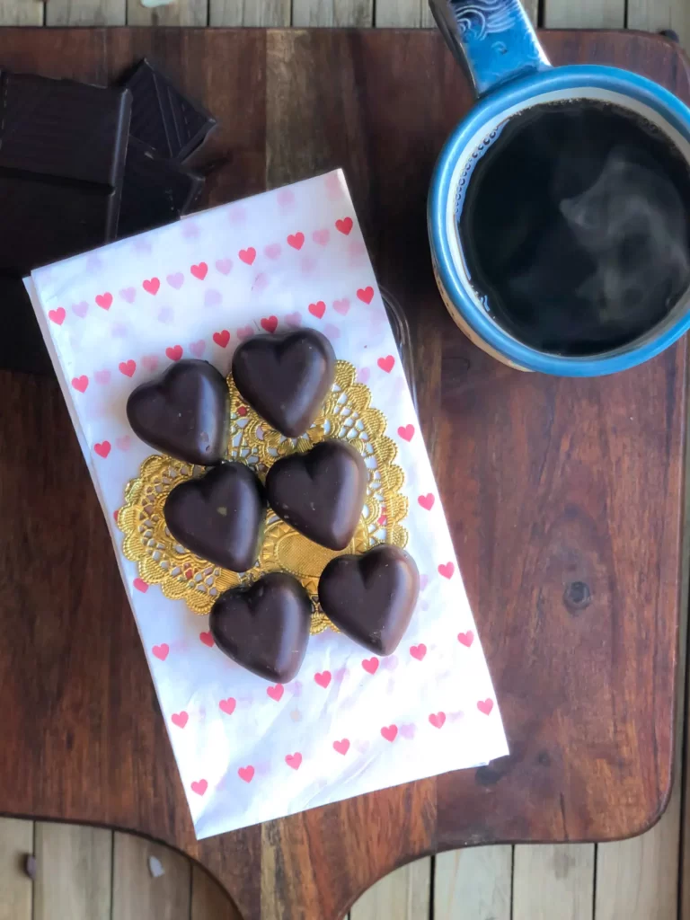 gluten free chocolate hearts with a mug of coffee beside them