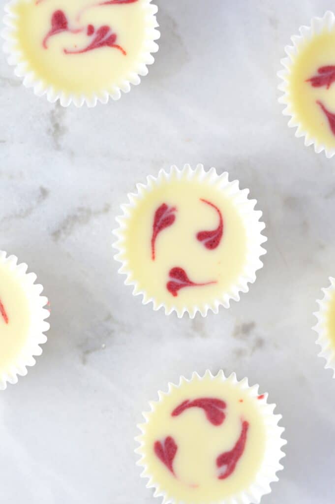 mini white chocolate cups on a marble worktop