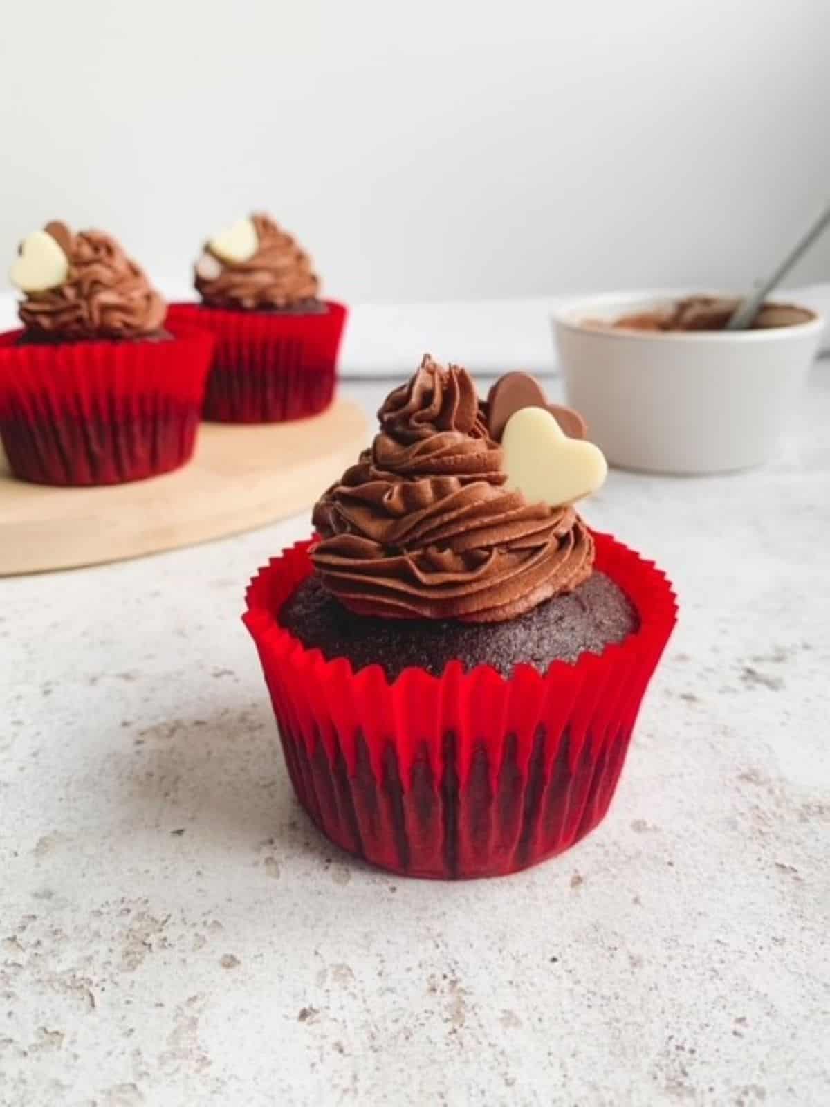 chocolate cupcakes in a red paper case decorated with chocolate hearts