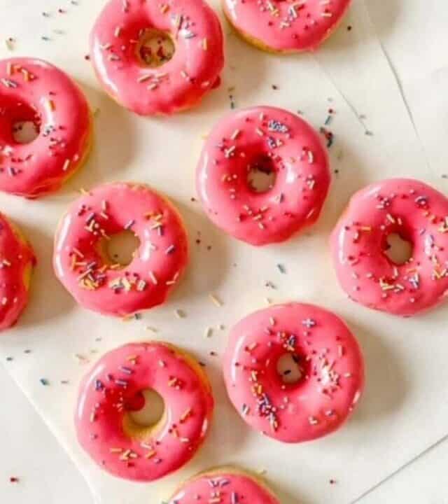 gluten free baked donuts with pink glaze and sprinkles.