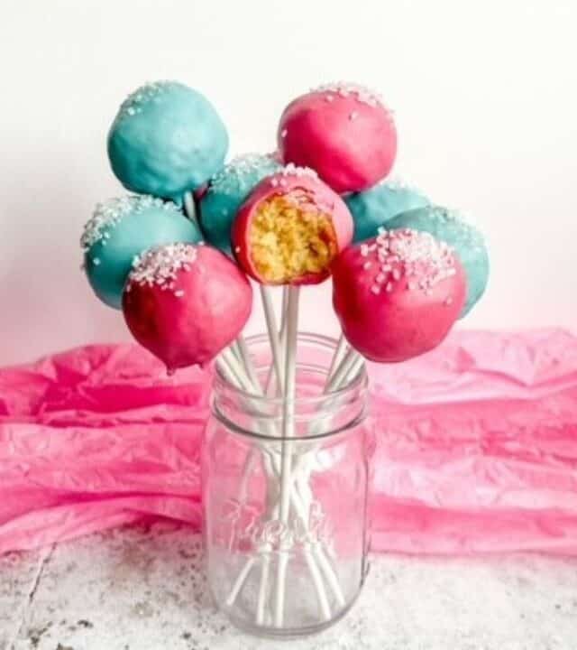 Pink and blue cake pops in a mason jar.