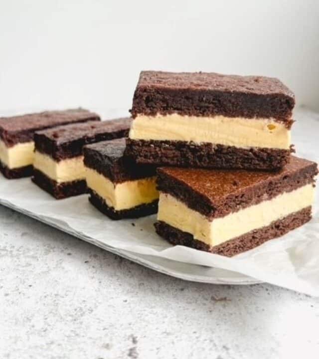 Brownie Ice cream sandwich slices stacked in a serving tray on a white background.