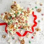 Star shaped serving bowl with chocolate crunch ingredients with a red ribbon beside the dish.