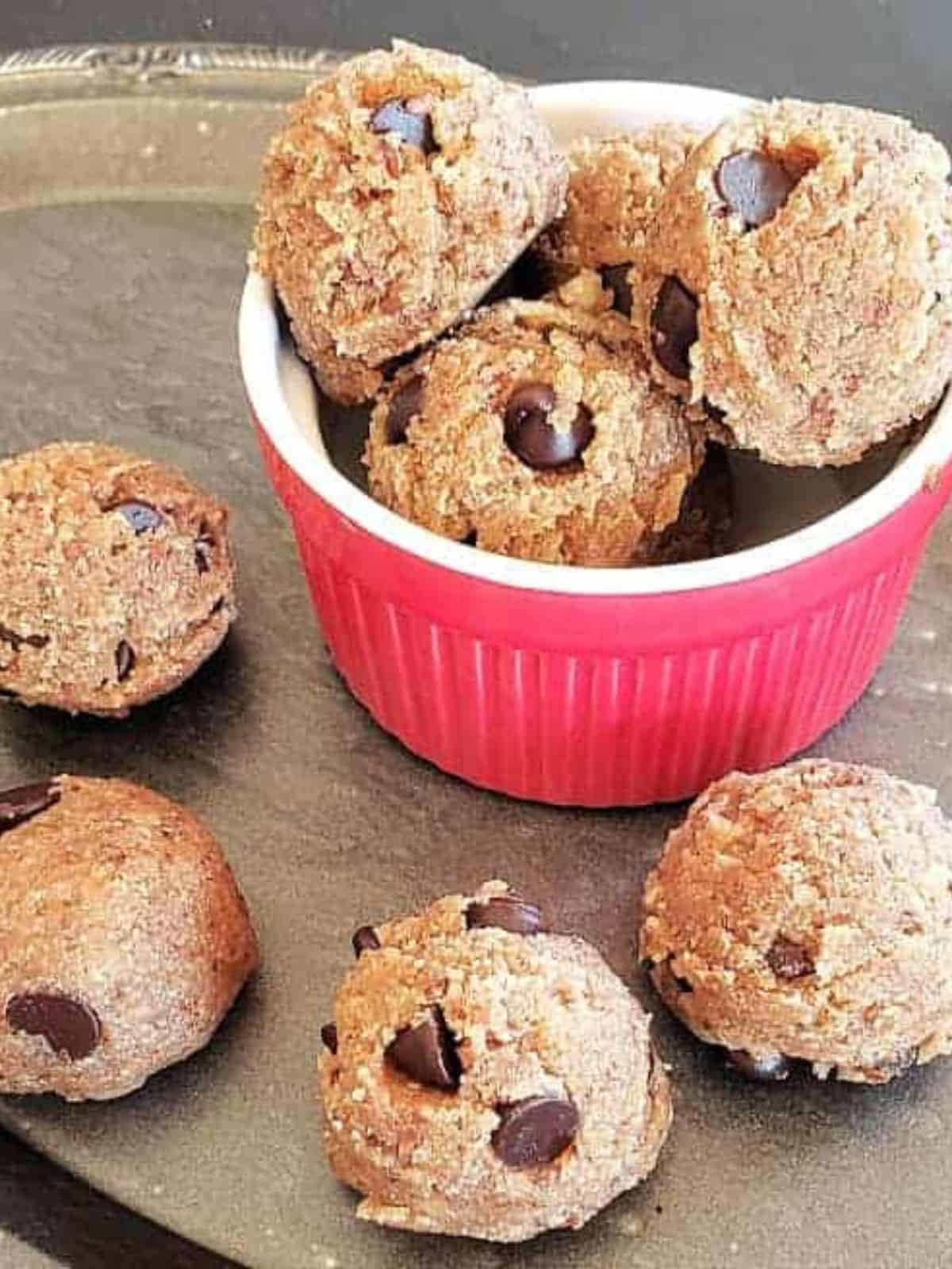 Cookie dough balls in a small red bowl.