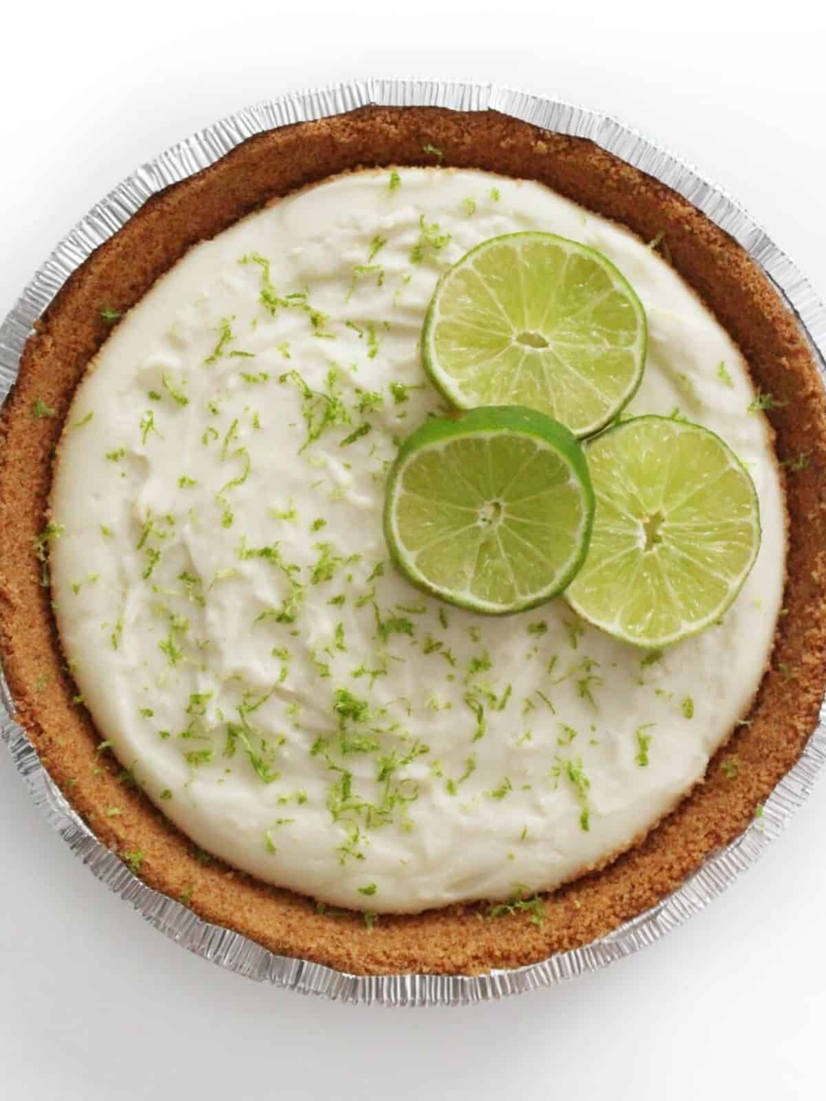 Overhead shot of key lime pie on a white background.