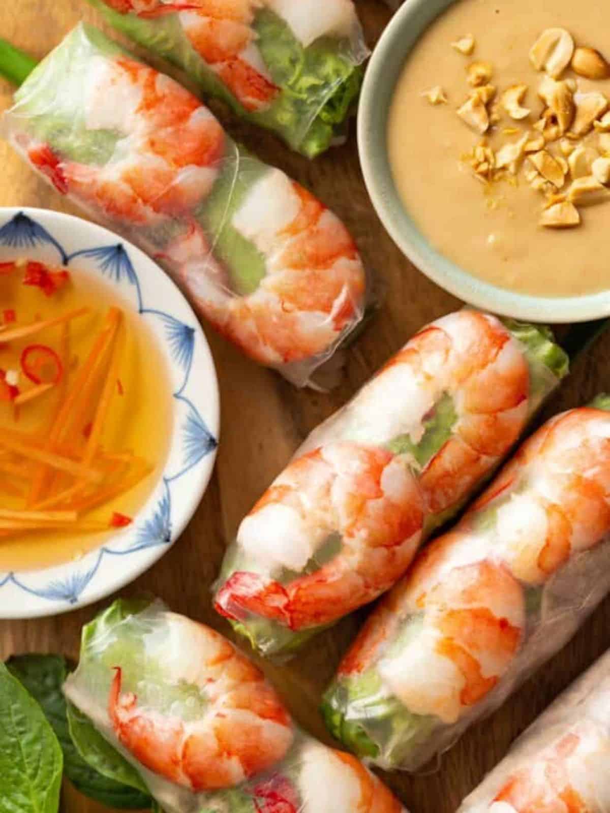 Vietnamese Fresh Spring Rolls next to a bowl of dips.