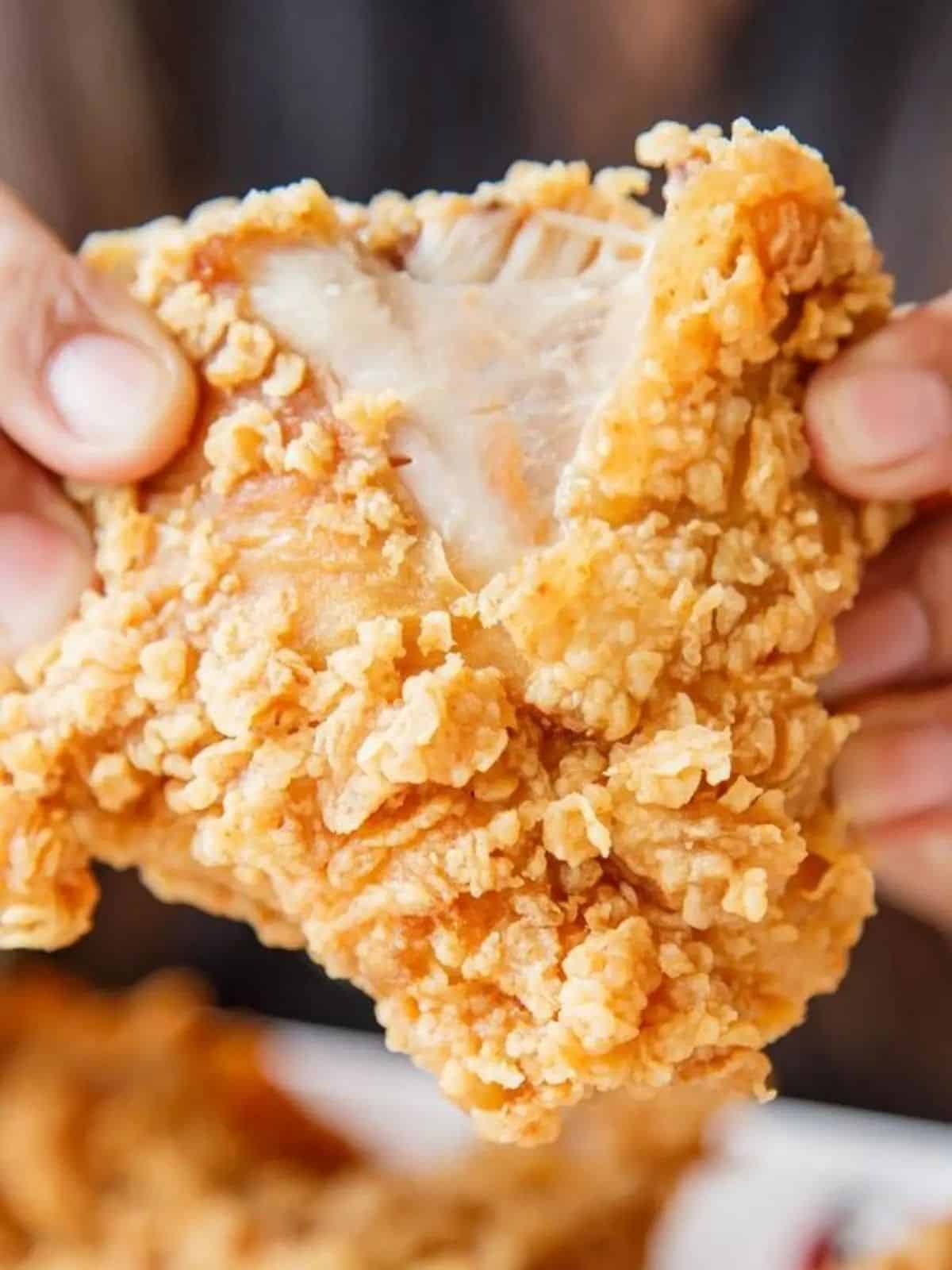 Close up of pulling apart Gluten Free Fried Chicken.