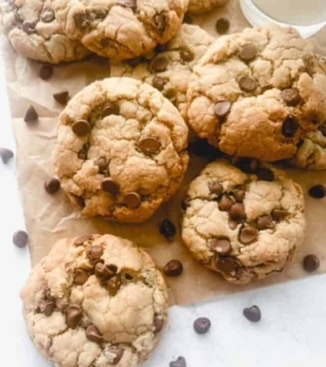 Close up of gluten free chocolate chip cookies on brown parchment paper.