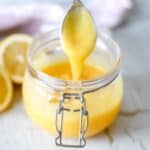 Lemon Curd in a mason jar with a spoon.