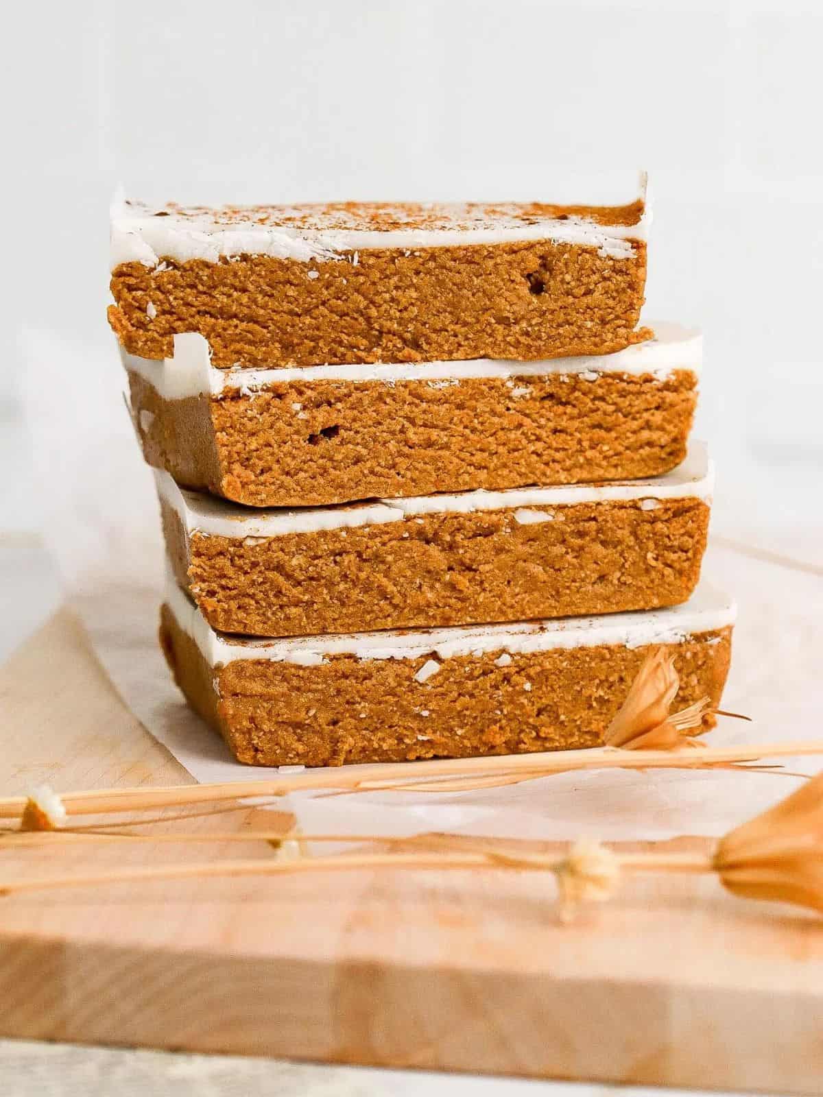 A stack of slice pumpkin protein bars with a white background.