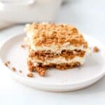 A slice of speculoos tiramisu on a white plate.