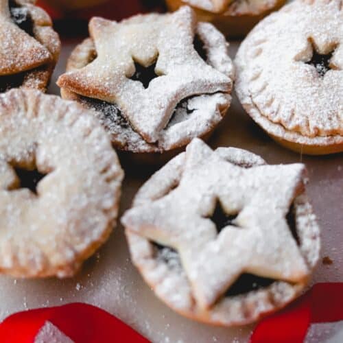 Close up of gluten free mince pies on a white plate.
