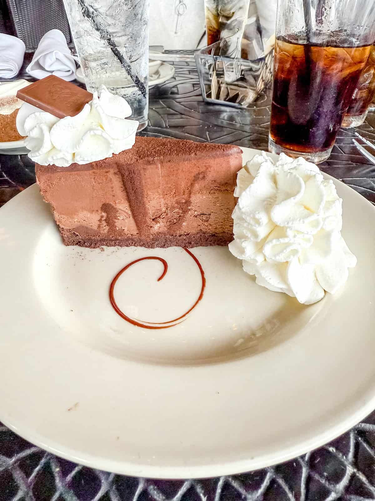 Chocolate cheesecake on a white plate.