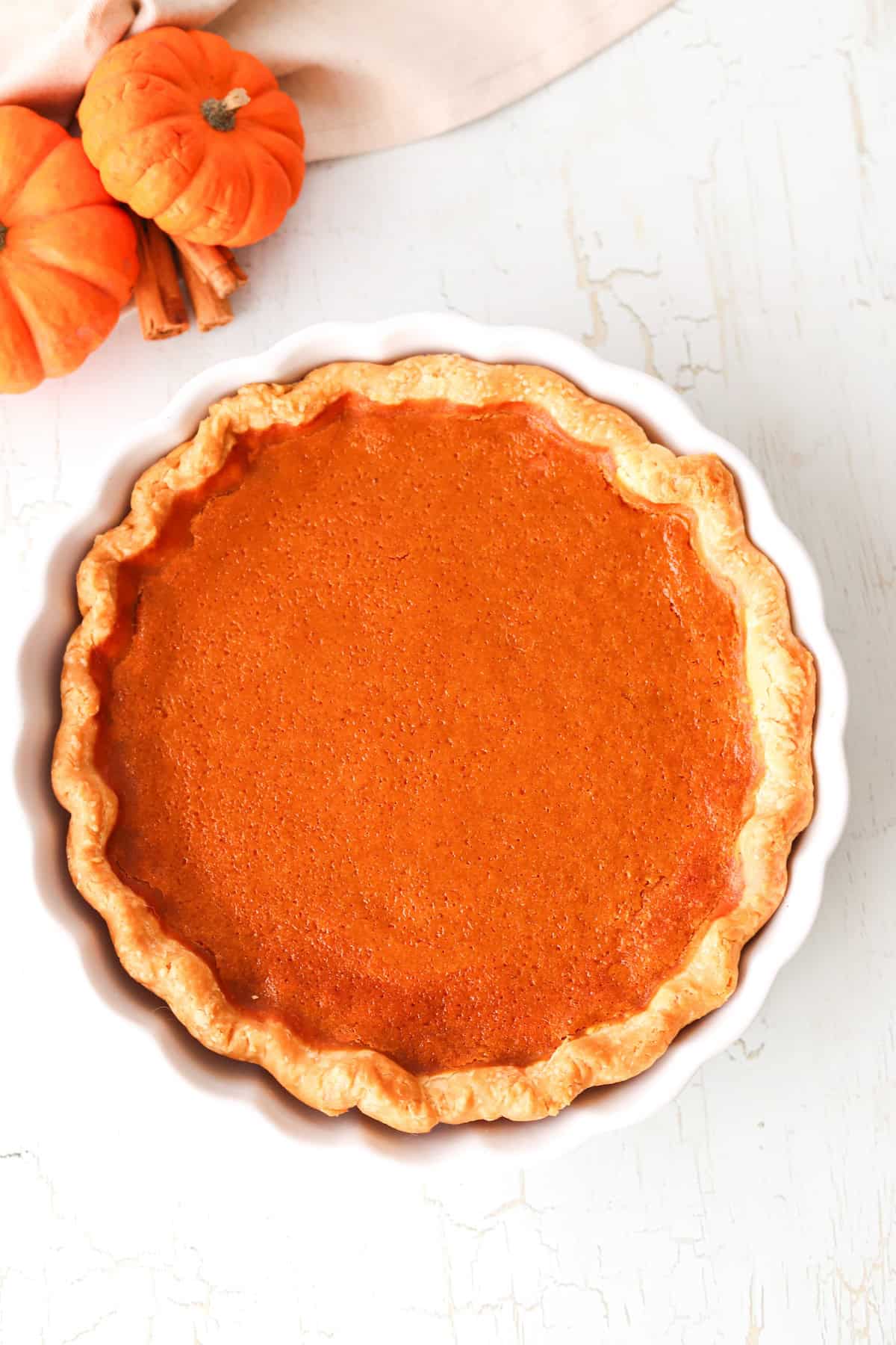 Overhead shot of gluten free pumpkin pie in a white pie dish.