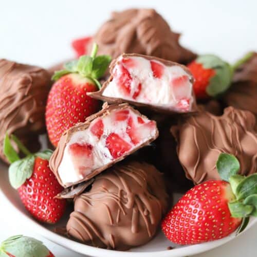 Chocolate strawberry yogurt clusters on a plate with one sliced in half to reveal the filling.