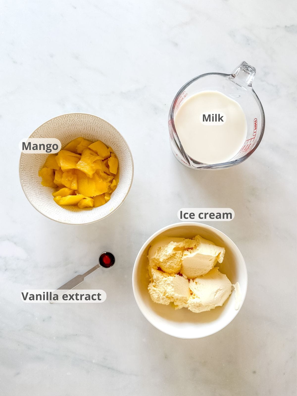 Overhead image of ingredients for a mango milkshake recipe.