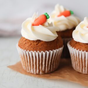 Close-up image of gluten free carrot cake cupcakes on a white background.
