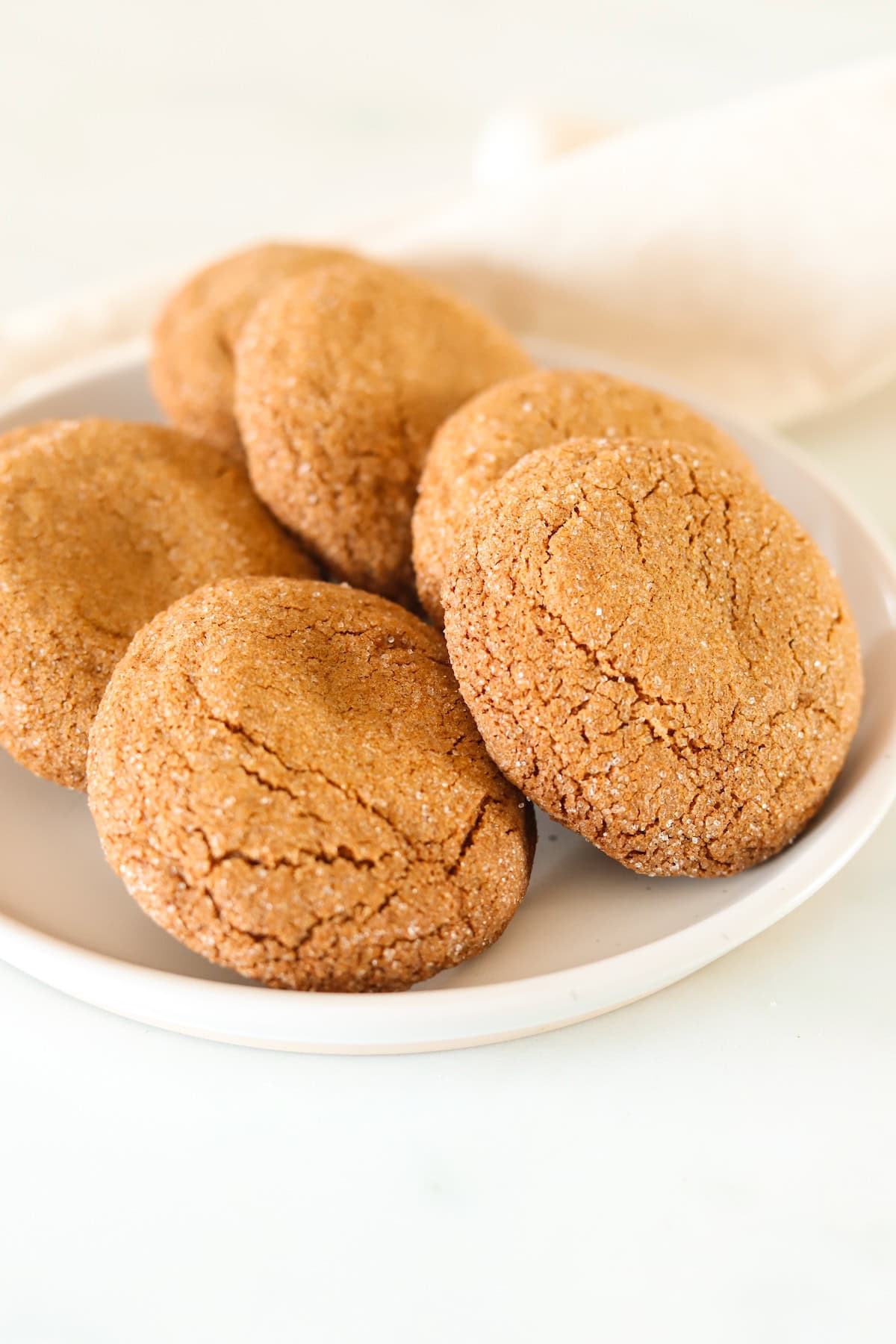 Gluten free gingersnap cookies on a white plate.