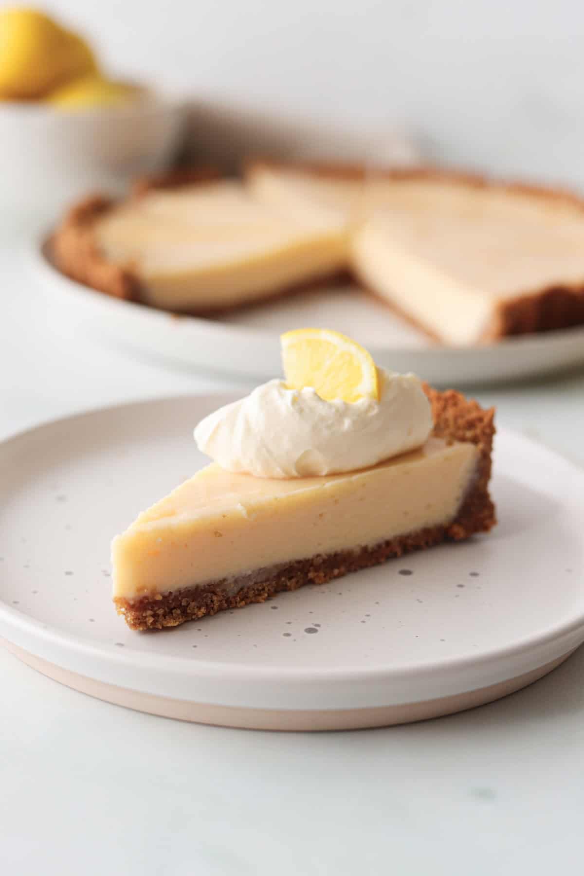 A slice of gluten free lemon pie on a white plate.