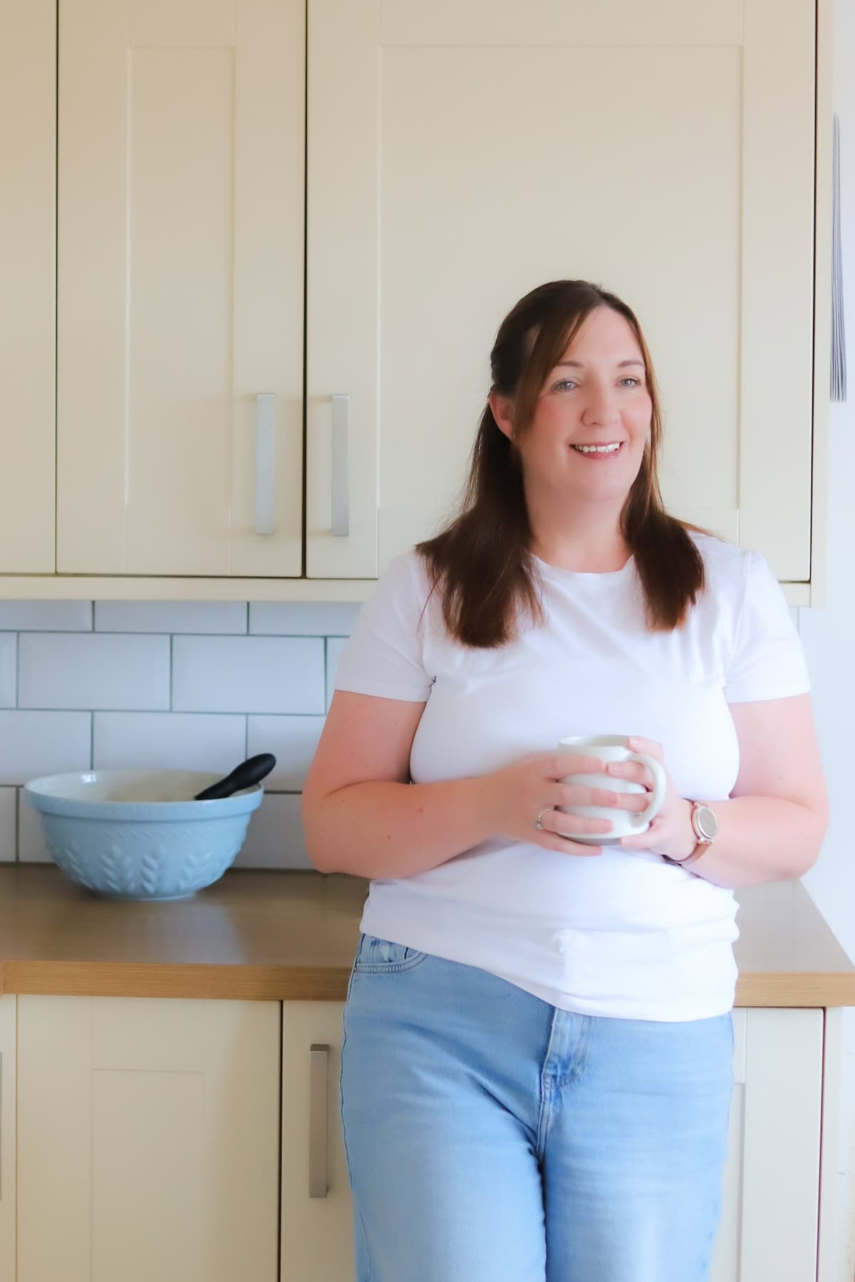 Woman standing in a kitchen.